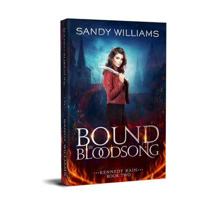 This image features the cover of the paperback book titled "Bound by Bloodsong" by Sandy Williams. The cover artwork captures an intense and dramatic scene with a woman holding a bloody knife, surrounded by a vividly depicted dark and stormy background.